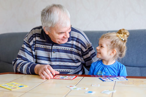 Grandfather and Granddaughter Playing Bingo